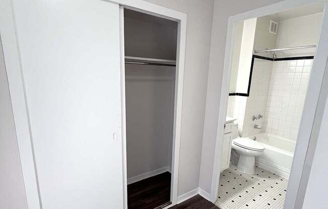 A white bathroom with a toilet and a walk in shower.