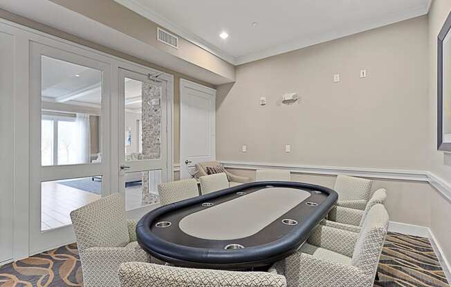 a game room with a poker table and chairs