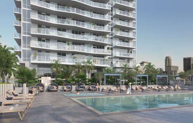 A large white building with a pool in front.