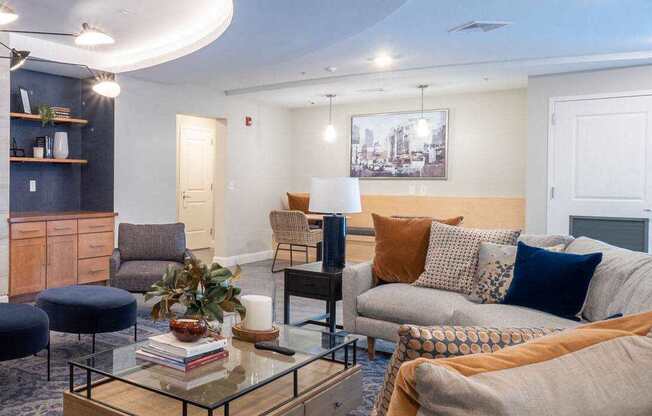 A contemporary social lounge with cozy seating arrangements, a fireplace, and a TV.