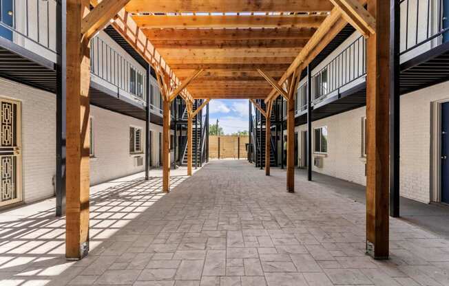 a building with a wooden roof and a walkway