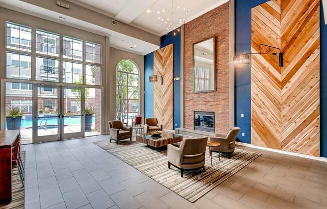 a lobby with a fireplace and chairs and a rug