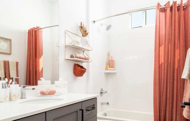 a bathroom with a shower and a sink and a toilet