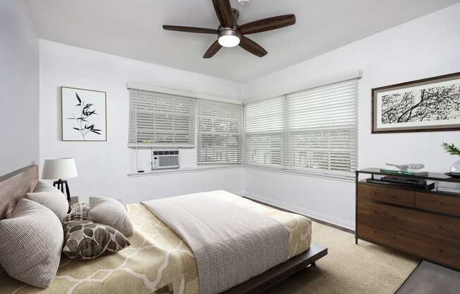 a bedroom with a large bed and a ceiling fan