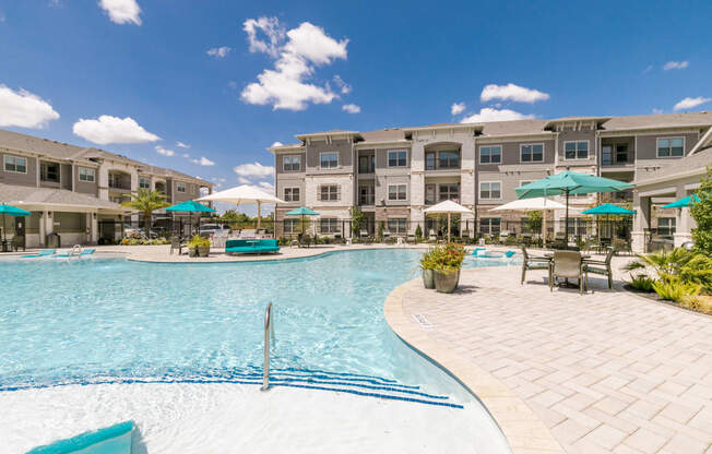 Relaxing Pool Area With Sundeck at Cue Luxury Apartments, Cypress