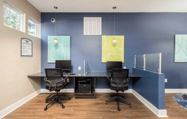 a conference room with desks and chairs and paintings on the wall