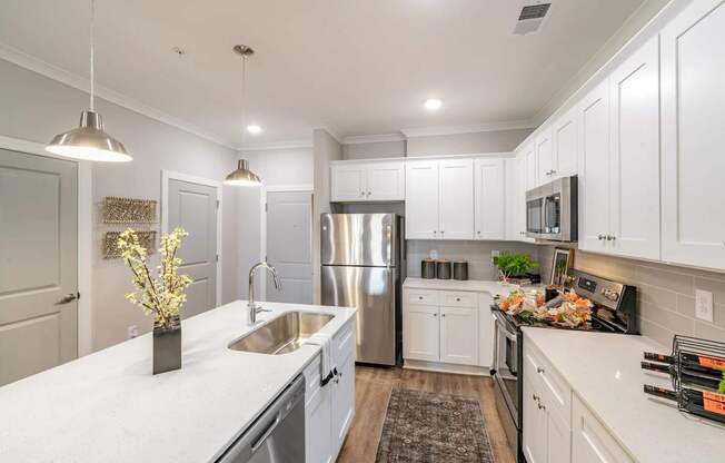 A modern kitchen with stainless steel appliances and white cabinets. at The One at Spartanburg, Spartanburg, SC