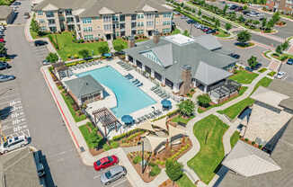 A large building with a pool in front of it.