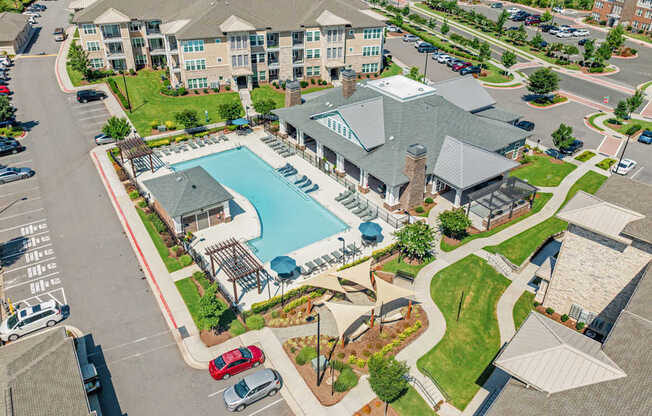 A large building with a pool in front of it.