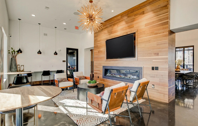 Resident lounge with modern lighting and a wooden partition at the preserve apartments.