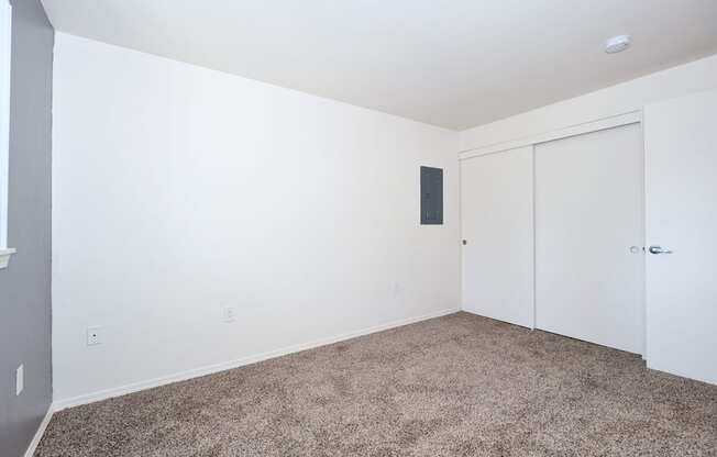 a bedroom with a carpeted floor and white walls