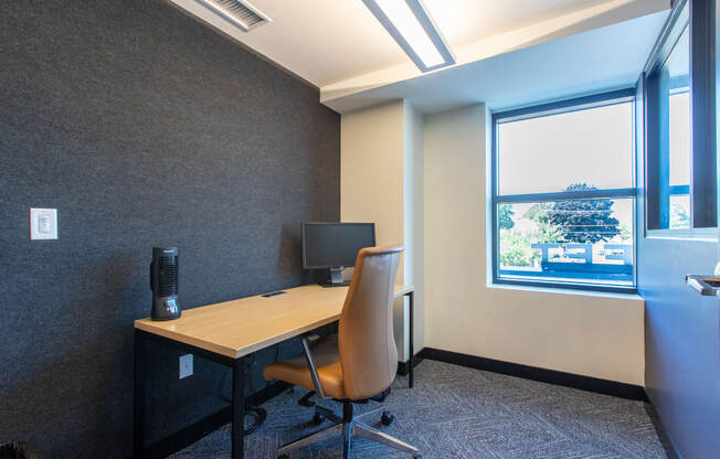 a workspace with a computer monitor and chair