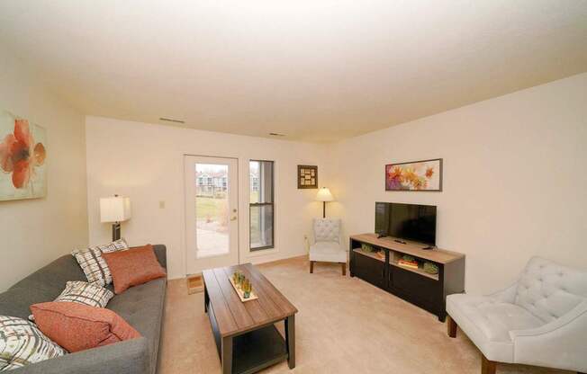 Living Room With French Door to Patio at Emerald Park Apartments, Michigan