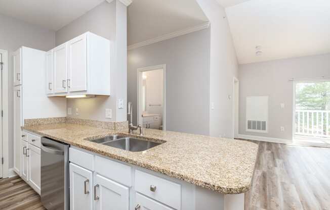 Drum Hill 2 Bedroom Apartment Kitchen with granite countertops, white cabinetry and large family room