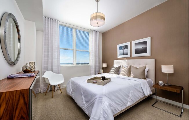 a bedroom with a bed and a desk with a chair at Regatta at New River, Fort Lauderdale, 33301