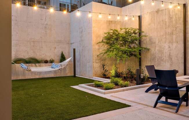 a courtyard with a hammock hanging on the wall