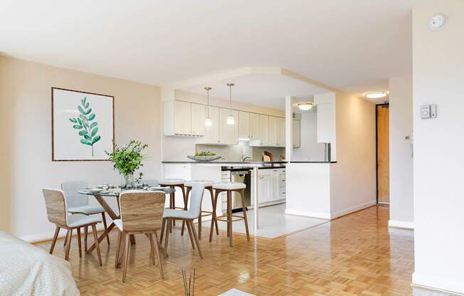 A dining room with a table set for six with a plant on the table.