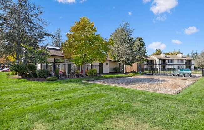 A house with a green lawn and a tree with yellow leaves.