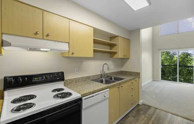 a kitchen with wooden cabinets and a white stove top oven at Sir Gallahad Apartment Homes, Bellevue, 98004