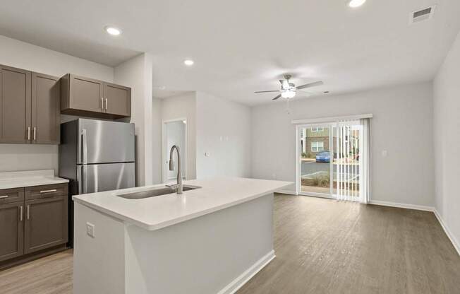 A kitchen with a white countertop and a stainless steel refrigerator.