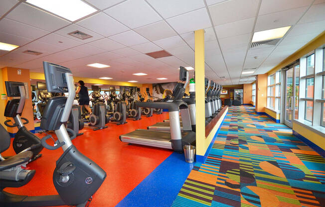 a rendering of a fitness gym with cardio machines and weights