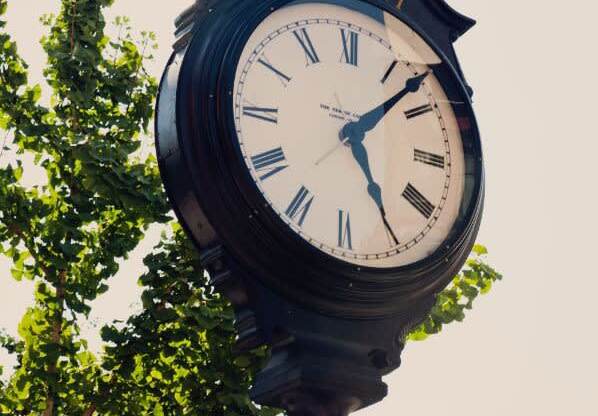 a large clock on top of a pole at One Ten Apartments, Jersey City , New Jersey