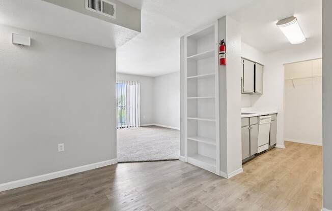 A room with a white door and a window with blinds.