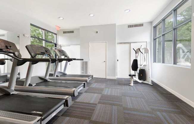 A gym with treadmills and a weight machine.