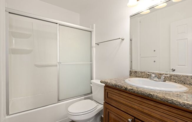 a bathroom with a sink toilet and shower