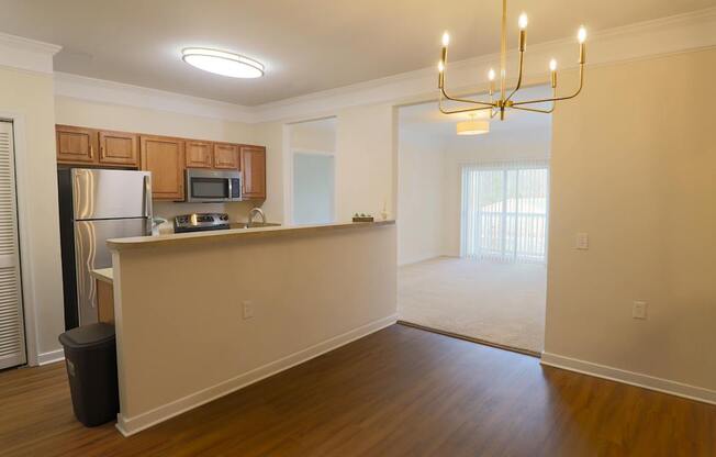 A kitchen with wooden cabinets and a refrigerator.