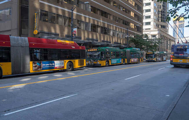 A red and yellow bus is parked on the side of the street