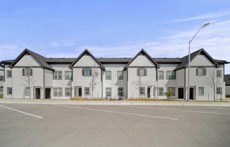 an empty parking lot in front of an apartment building