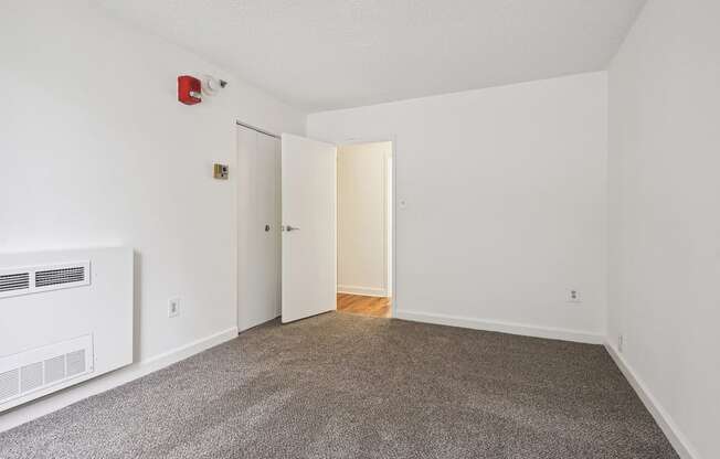 an empty room with a carpeted floor and white walls