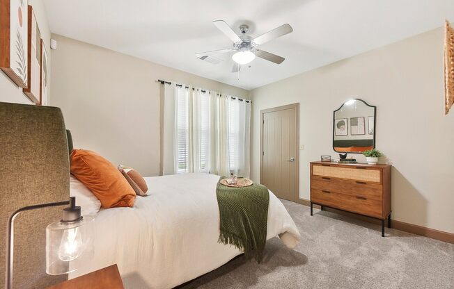 a bedroom with a bed and a ceiling fan at Lakeline East Apartments, Texas, 78613