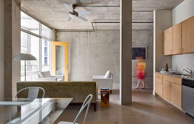 A modern kitchen with a dining table and chairs.