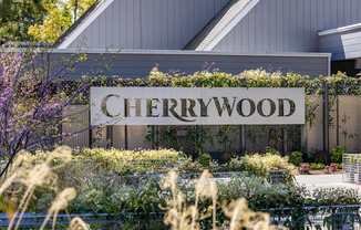 A sign that says Cherrywood in front of a building.