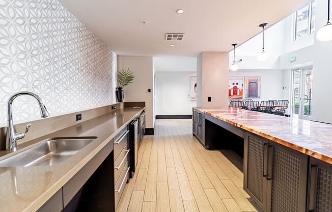 a large kitchen with a long counter and a sink