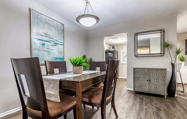 the dining room of a home with a table and chairs