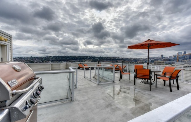 Rooftop BBQ and Picnic Area with Grill, Red Patio Umbrella and Chairs