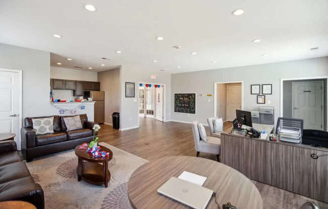 A modern living room with a black leather couch and a wooden coffee table.