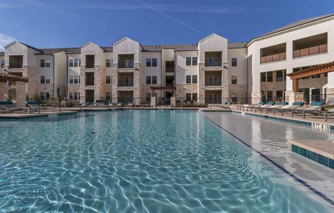 Relaxing Pool Area With Sundeck at McCarty Commons, San Marcos, TX