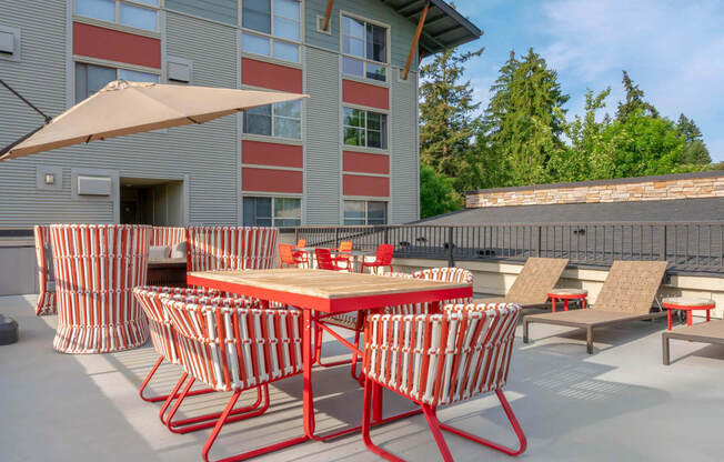 a patio with tables and chairs and a building in the background  at Delano, Washington