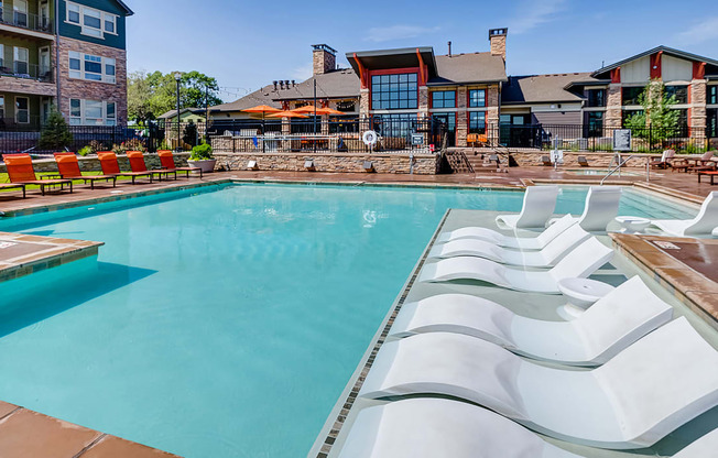 Pool with in water lounge chairs at Windsor at Pinehurst, Lakewood, Colorado