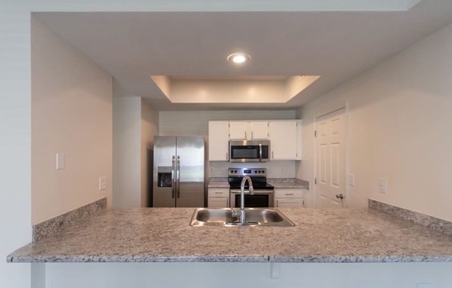 This is a photo of the kitchen of the 1500 square foot 3 bedroom, 2 and a half bath with 2-car garage Bellbrook floor plan at Washington Park Apartments in Centerville, OH.