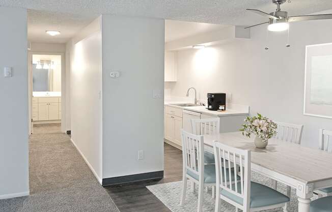 an open kitchen and dining room with a white table and chairs