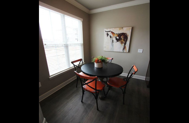 Dining area with 4 chair table and large window.