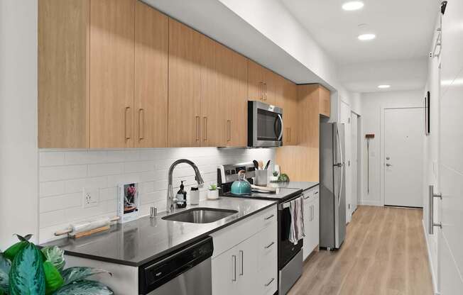 A modern kitchen with wooden cabinets and stainless steel appliances.