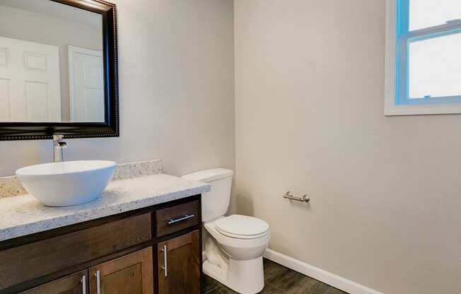 Bathroom vanity and toilet in remodeled apartment