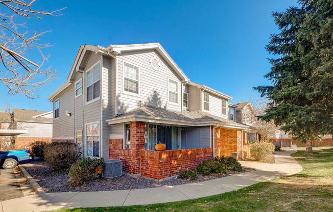 the front of a house with a sidewalk in front of it