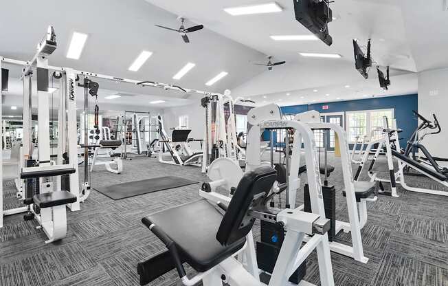 A gym with a variety of equipment including a leg press machine.